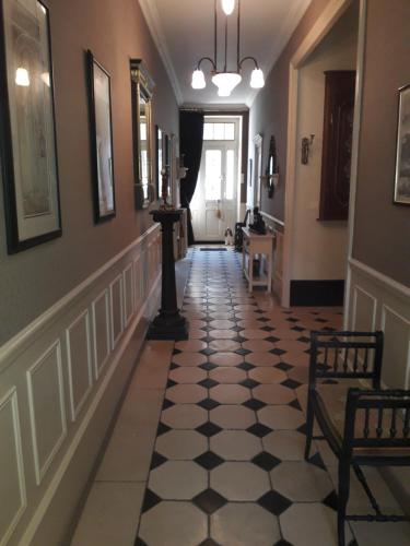 a hallway with a black and white checkered floor at La Belle Epoque in Époisses