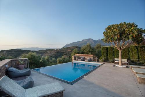 a swimming pool with a view of the mountains at Villavia Residence - Sorocco & Ostria Retreats with Pool access in Megáli Mandínia