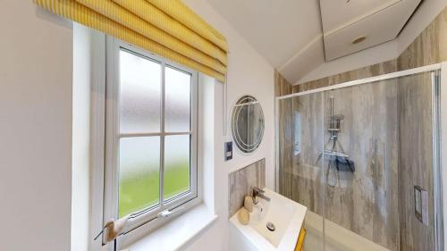 a bathroom with a sink and a window at Salty Dog at The Bay Filey, sleeps 4, 2 dogs welcome for free too in Filey