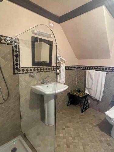 a bathroom with a sink and a shower at Riad Al Madina in Essaouira