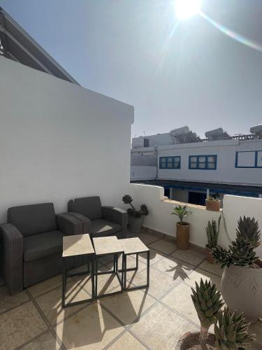 a living room with a couch and a table at Riad Al Madina in Essaouira
