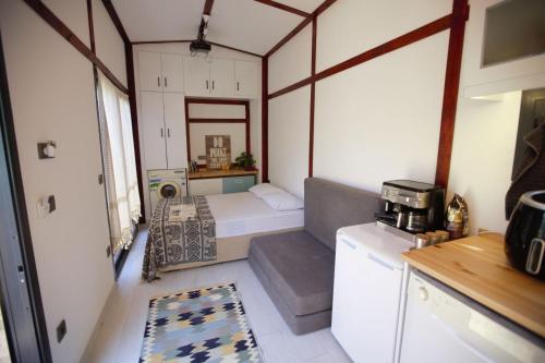 a small room with a bed and a kitchen at Athena Tiny House in Bodrum City