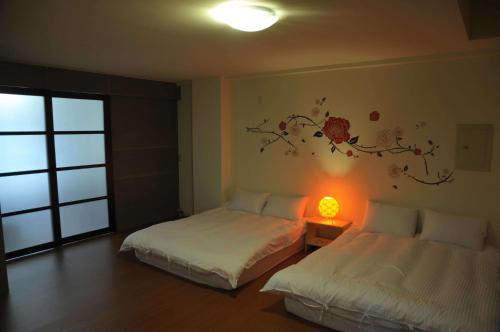Cama o camas de una habitación en Sanyi Happiness B&B
