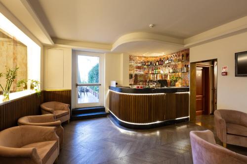 a bar in a restaurant with chairs and a window at Hotel Silla in Florence