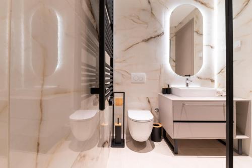 a bathroom with a sink and a toilet and a mirror at Villa Isola in Murter