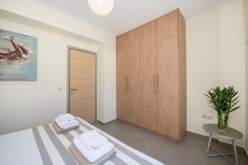 a room with a closet and a table and a chair at Ashlin seaside Luxury Apartment in Chania Town