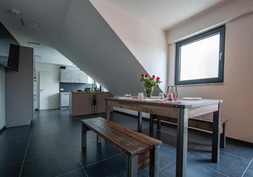 a dining room with a table and a bench at Blauer Stein Apartments WH5 in Pulheim