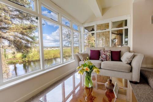 a living room with a couch and large windows at Killarney View House B&B in Killarney