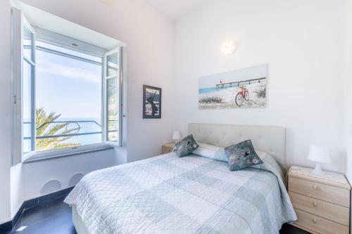 ein weißes Schlafzimmer mit einem Bett und einem Fenster in der Unterkunft NEW 2024 Hanging Garden in Corniglia