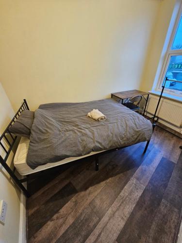a bed with a dog laying on top of it at Double room with Shared Bathroom (3) in Manchester