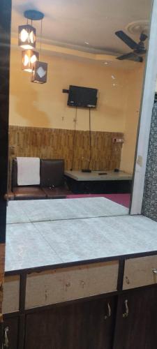 een kamer met een bank en een flatscreen-tv bij Rajs Lodging & Fooding (Guest House) in Calcutta