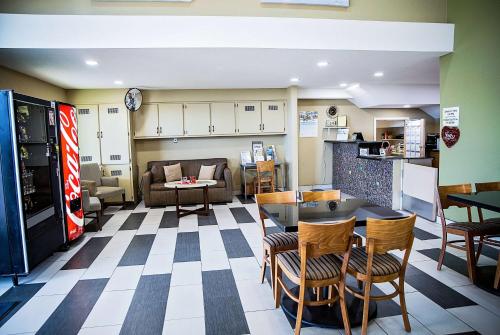 a kitchen and living room with a table and chairs at Super 8 by Wyndham Holbrook in Holbrook