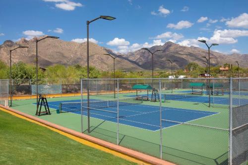 a group of tennis courts with mountains in the background at Westward Look Wyndham Grand Resort & Spa in Tucson