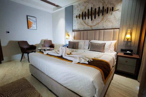 a bedroom with a large white bed in a room at AJ GRAND ELITE HOTEL in Mangalore