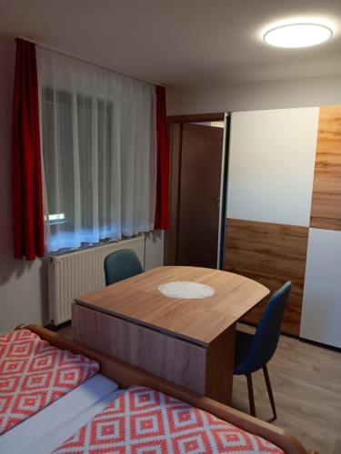 a room with a table and chairs and a bed at turistična kmetija pr mark in Trebče