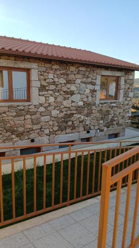 a wooden fence in front of a house at Alojamento Local Casa da Eira in Murça