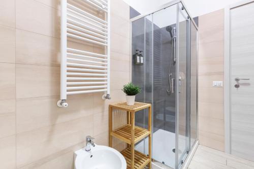 a bathroom with a shower and a toilet and a sink at Luciano Secret Garden Apartment in Rome