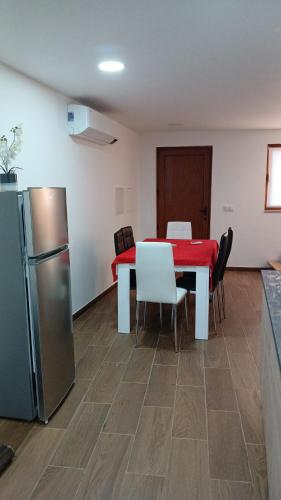 a dining room with a table and a refrigerator at Alojamento Local Casa da Eira in Murça