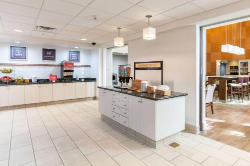 a large kitchen with white cabinets and a counter at Hampton Inn & Suites Hartford-Manchester in Manchester