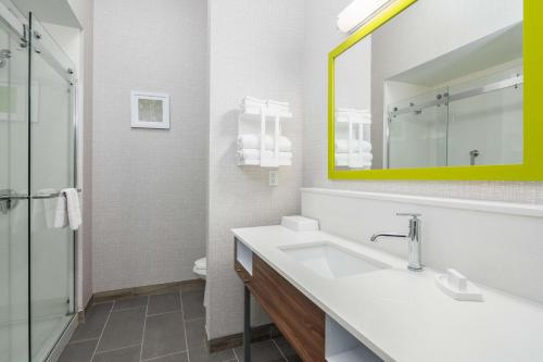 a white bathroom with a sink and a mirror at Hampton Inn & Suites Hartford-Manchester in Manchester
