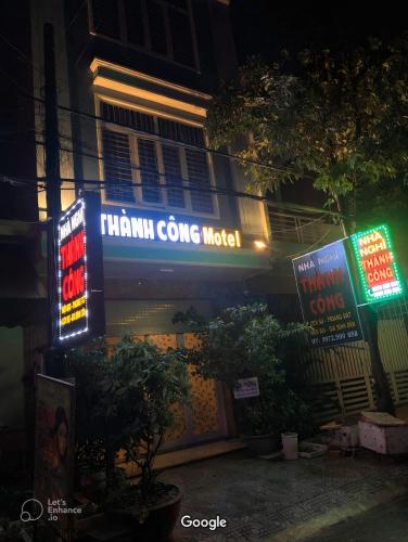 a building with neon signs on the side of it at Nhà nghỉ Thành Công in Danang