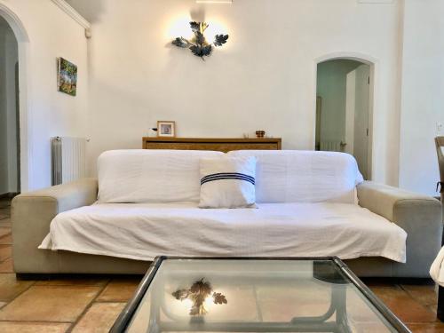 a living room with a couch and a glass table at Terre de Sel in Grimaud