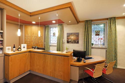an office with a desk with a computer on it at Hotel Goldener Karpfen in Aschaffenburg