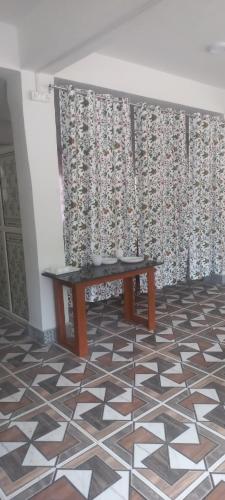 a table in a room with a patterned wall at AADIL RESTAURANT in Wāngom