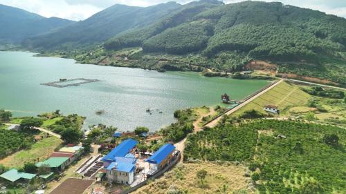 an aerial view of a lake with a house at Kala view homestay in Di Linh