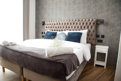 a bedroom with a large bed with a large headboard at BB De Rohan in Żebbuġ