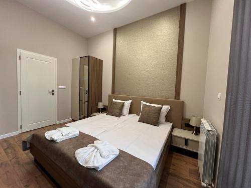 Postel nebo postele na pokoji v ubytování Хотел VIP APART HOUSE