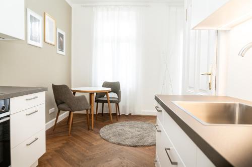 a kitchen with a sink and a table at twenty five - work & life Apartments in Amstetten