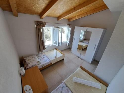 a small room with a bed and a mirror at Vila Angelina in Maslenica