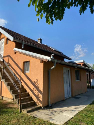 a house with stairs leading up to it at Vikendica na dan in Novi Sad