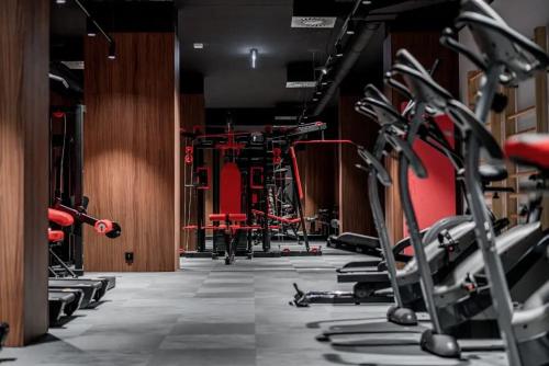 a gym with a row of tread machines at STAR Apartments Gdańsk - Gym & Sauna in Gdańsk