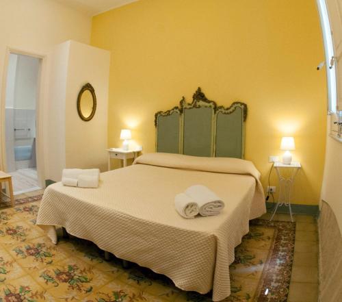 a bedroom with a bed with towels on it at Rooms and Breakfast GranVeliero in Trapani
