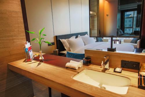a bathroom with a sink and a large mirror at Fulitai International Hotel in Yantai
