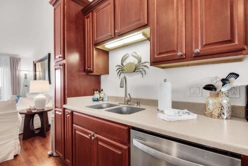 a kitchen with wooden cabinets and a sink at Baywatch C10 in Pensacola Beach