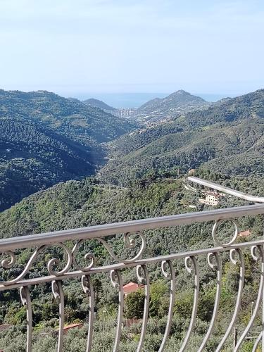 a metal railing with a view of a valley at Casa ivo in Perinaldo