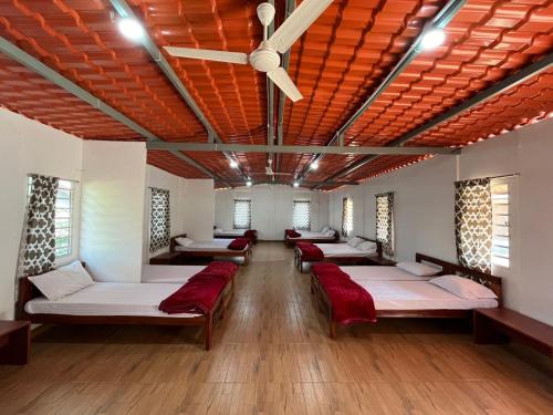 a room with a bunch of beds in it at Ammara Eco Stays in Avathi