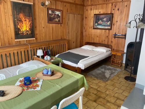 a bedroom with two beds and two tables and a fireplace at Kwatery Prywatne Hotelik in Barczewo
