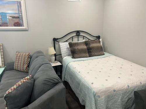 a bedroom with a bed and a bed and a couch at Room near the beach in long branch in Long Branch