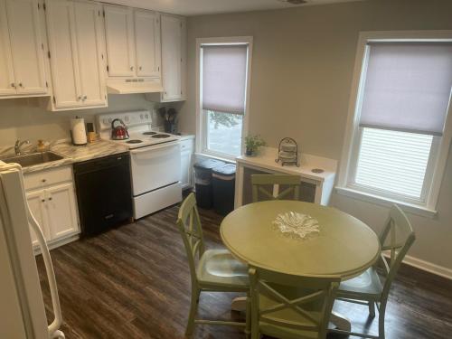 a kitchen with a table and a small table and chairs at Room near the beach in long branch in Long Branch