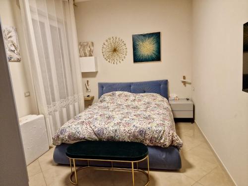 a bedroom with a bed and a chair in it at Novoli Chic: Cuore di Firenze in Florence