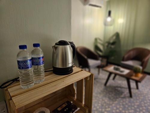 two bottles of water sitting on top of a table at 85 Boutique Hotel in Ipoh
