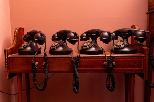 a group of old fashioned phones on a shelf at ART B&B in Blackpool