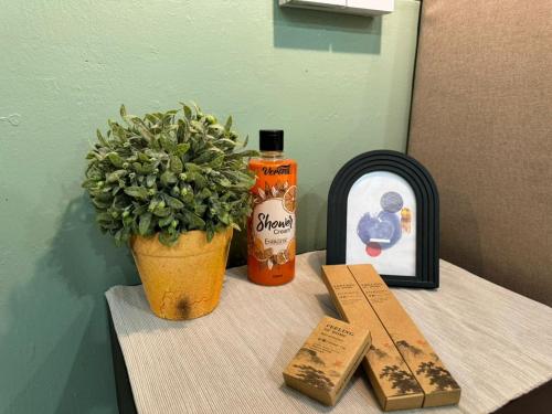 a table with a bottle of soap and a plant at 85 Boutique Hotel in Ipoh