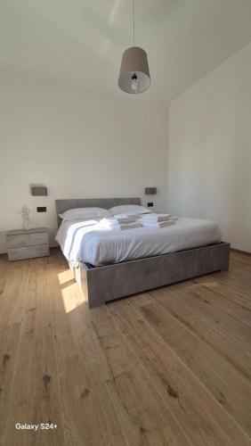 a bedroom with a bed and a wooden floor at Milano104 in Milan