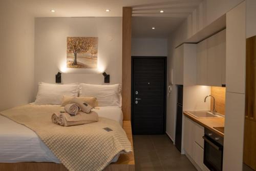a small bedroom with a bed and a sink in it at Thessalonian Suite I - 2 Steps from White Tower in Thessaloniki