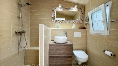 a bathroom with a toilet and a sink and a shower at Dans le centre du village d'ARS EN RE, charmante villa bien décorée in Ars-en-Ré
